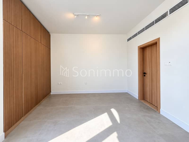 15 Sunlit Minimal Room with Wardrobe and Door. png