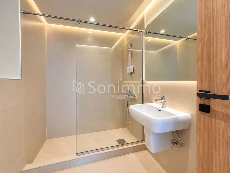 16 Warm Minimalist Walk-In Bathroom. png