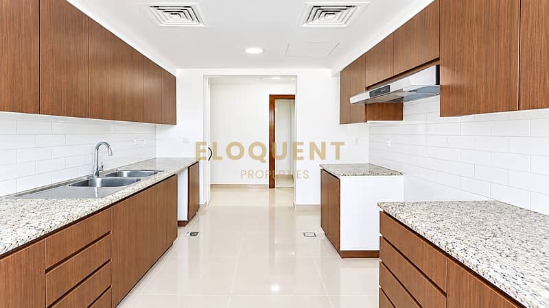 3 Modern Symmetrical Wood-Accented Galley Kitchen. png
