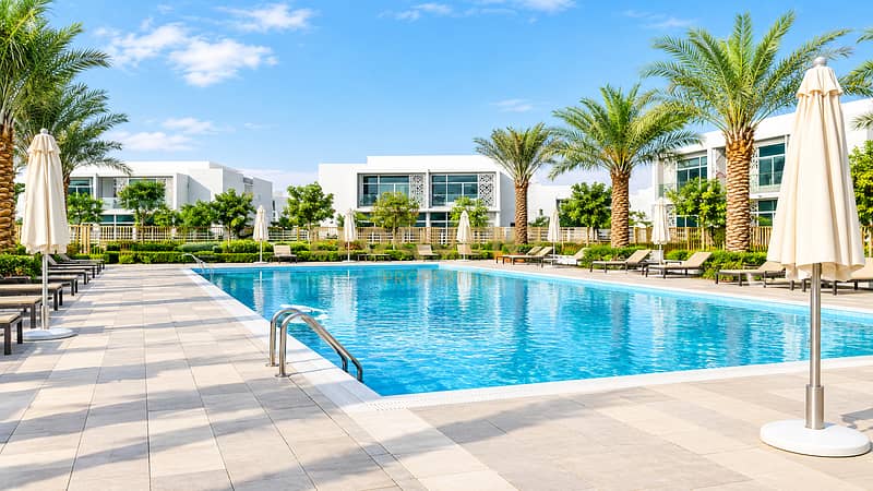 9 Modern Resort Pool with Palm-Lined Villas. png
