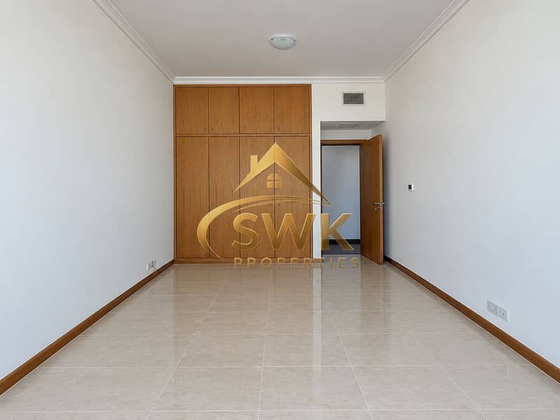 6 Minimalist Room with Wooden Wardrobe and Open Door. png