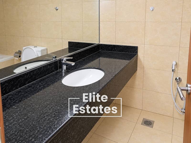 7 Modern Beige Marble Bathroom with Black Granite Vanity. png