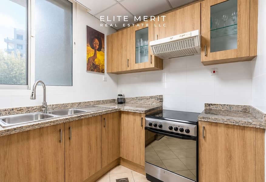 5 Bright L-Shaped Kitchen with Warm Wood Cabinets. png