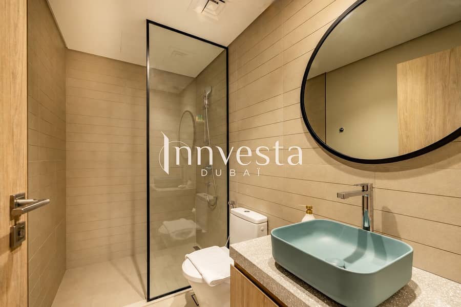 12 Beige-tiled bathroom sink and mirror-1. png
