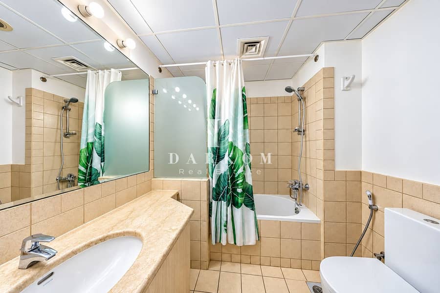 15 Modern Beige Bathroom with Tropical Leaf Curtain. png