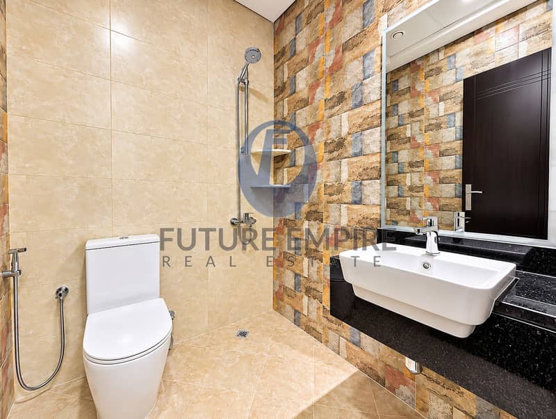 13 Modern Beige Marble Bathroom with Rustic Accent Wall. png