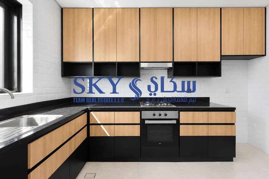 12 Modern Light Wood and Black Kitchen. png