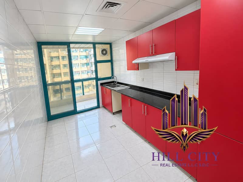 3 Bright Red Cabinet Kitchen with Balcony View. png