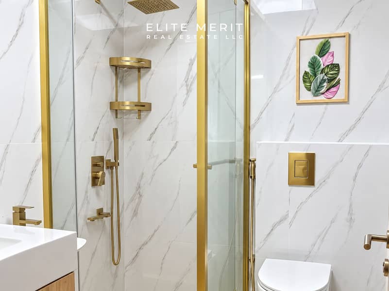 6 Luxurious Marble Bathroom with Brass Accents. png