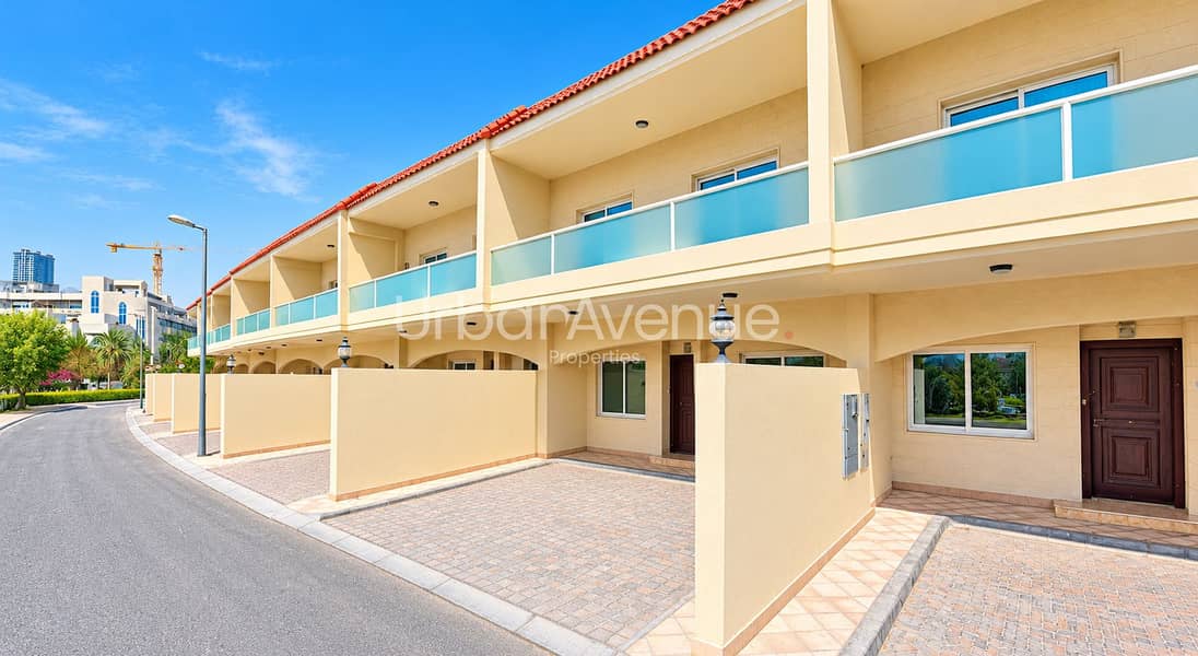2 Mediterranean Townhouses Under Blue Skies. png