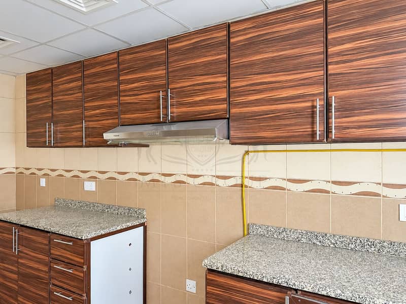 13 Modern Walnut Kitchen with FEBAR Hood. png