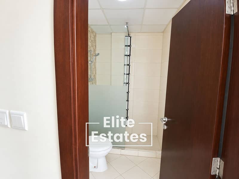 7 Modern Beige Bathroom Through Open Door. png