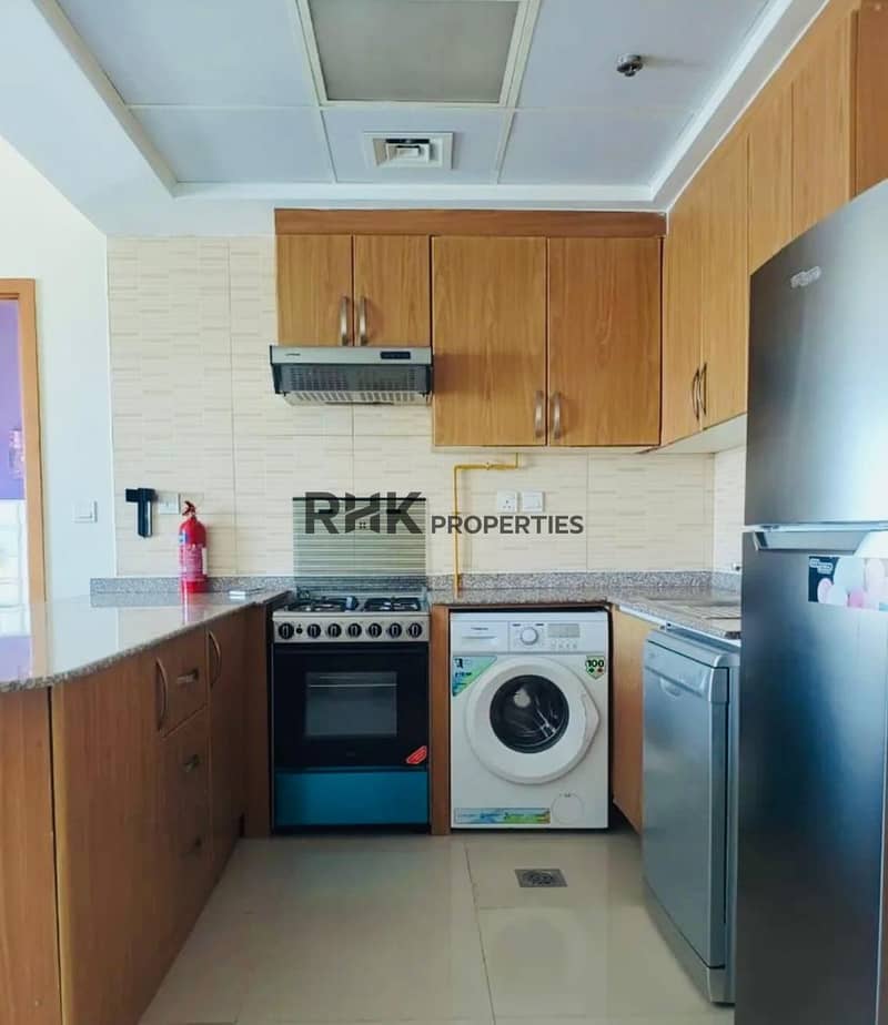 3 Kitchen with wooden cabinets, a built-in oven and gas hob, a washing machine, a dishwasher and a tall fridge-freezer.
