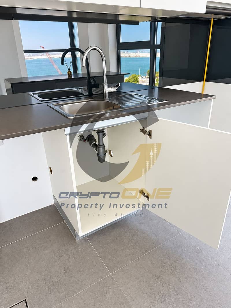 11 12_modern_kitchen_sink_with_harbour_view. png
