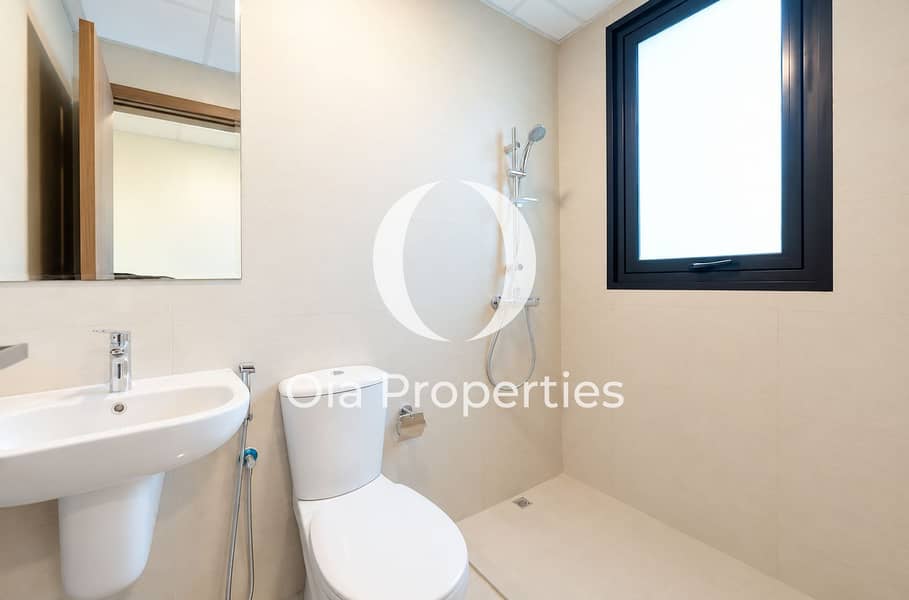9 Minimalist Beige Bathroom with Walk-In Shower. png