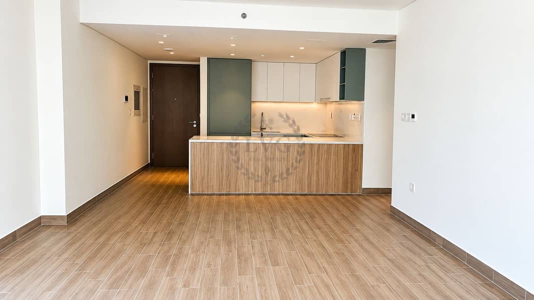 2 Modern Empty Apartment with Wood Island and Green Cabinets. jpg