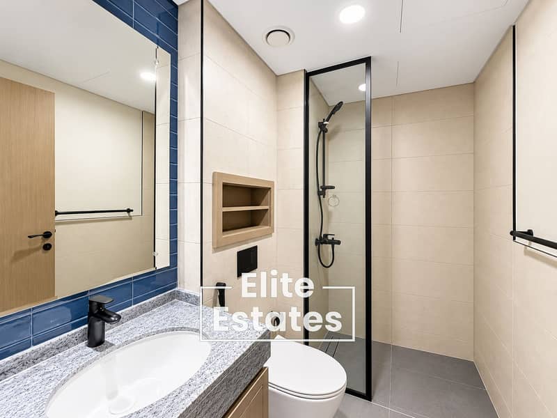 16 Modern Beige Bathroom with Blue Tile Accents. png