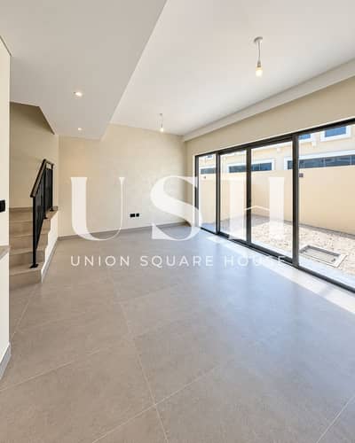4 Bedroom Townhouse for Rent in DAMAC Lagoons, Dubai - Minimalist Living Room with Courtyard Views (1). png