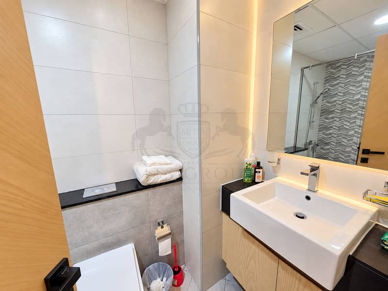 16 Modern Beige Bathroom with Warm Lighting. png