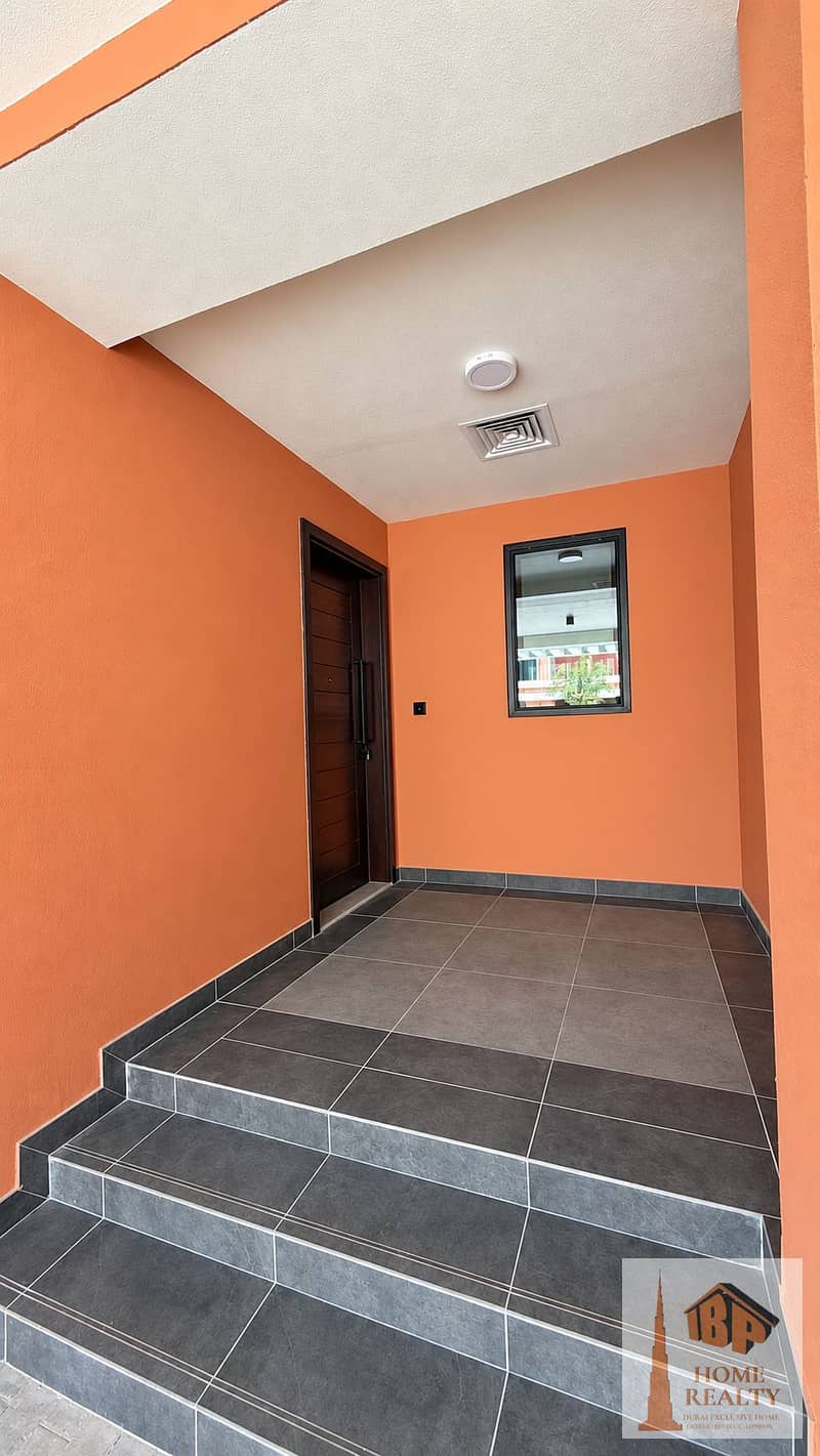 2 Bright Peach Entrance with Wooden Door. png