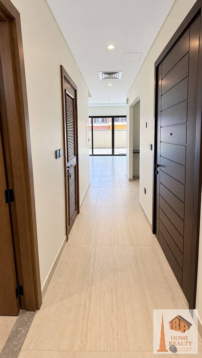 3 Sunlit hallway with dark wood doors. png