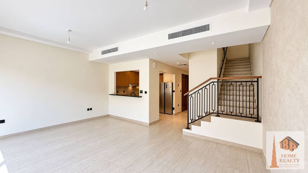 4 Brightened Empty Living Room with Staircase. png