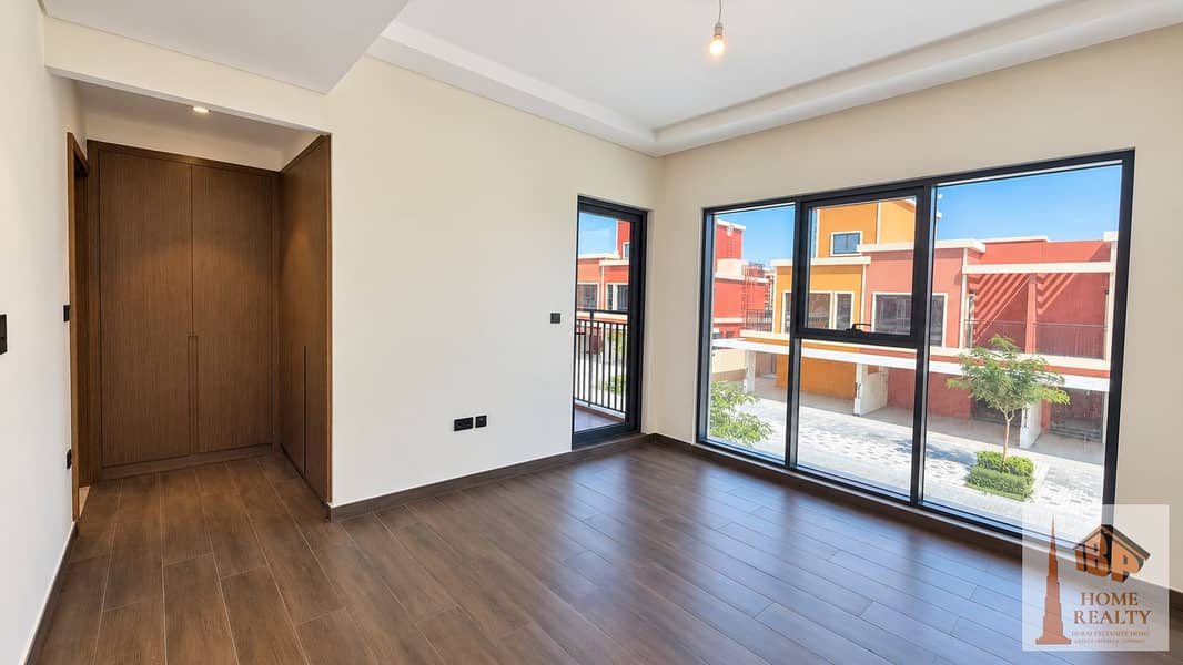 7 Brightened empty bedroom with balcony view. png