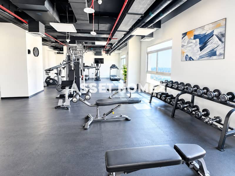 7 Bright Modern Gym Interior with Dumbbell Racks. png