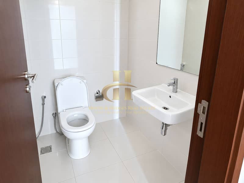 6 Bright Modern White-Tiled Bathroom. png