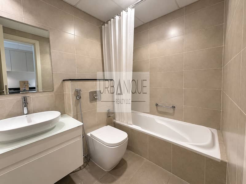 7 Modern Taupe-Tiled Hotel Bathroom. png