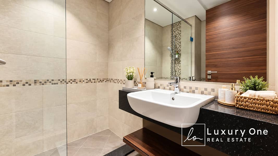 12 Modern Beige Stone Bathroom with Woven Accents. png