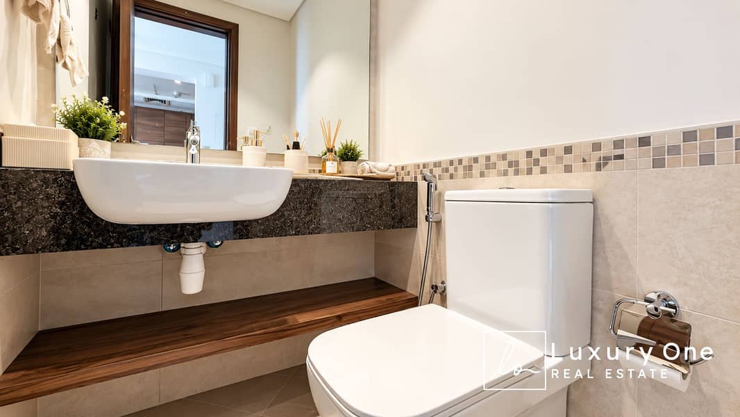 13 Modern Beige Bathroom with Wood Accents. png