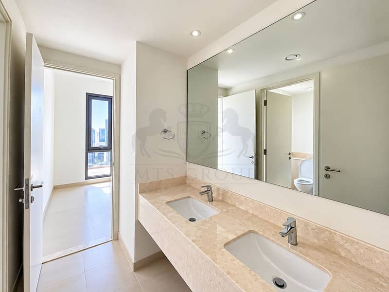 11 Modern Double-Vanity Bathroom with City View. png