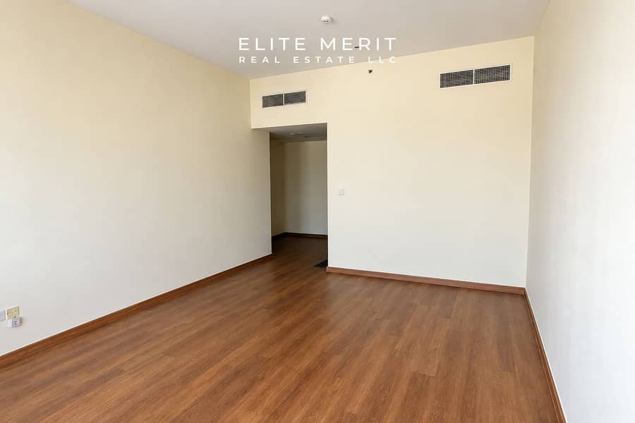 7 Minimal Beige Room with Wood Flooring and Vents. png