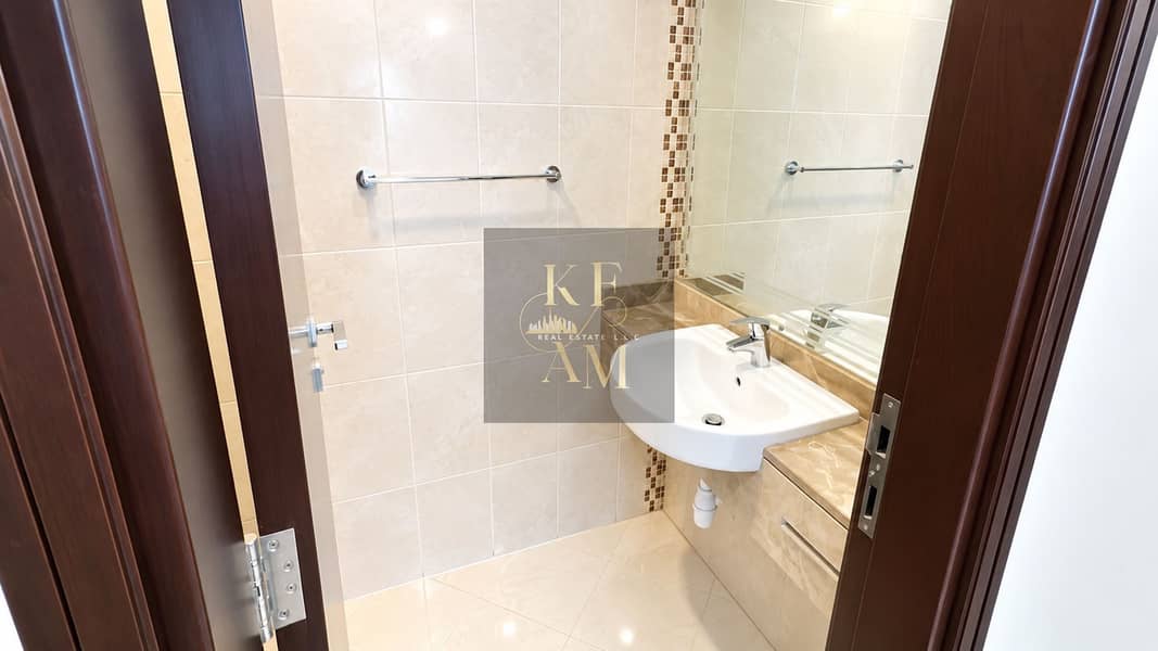 16 Modern Marble-Tiled Bathroom Entry. png