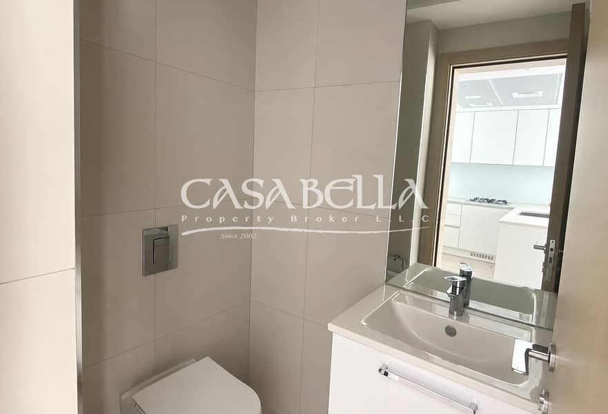 7 Minimalist Bathroom with Kitchen Reflection. png