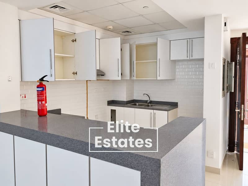 11 Bright Modern Kitchen with Fire Extinguisher. png