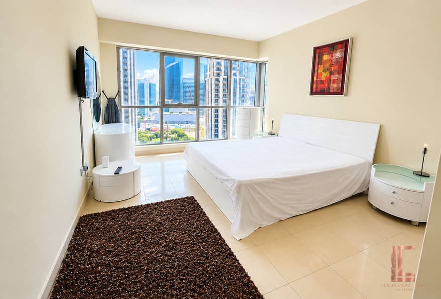 5 Sunlit High-Rise Bedroom with City Views. png