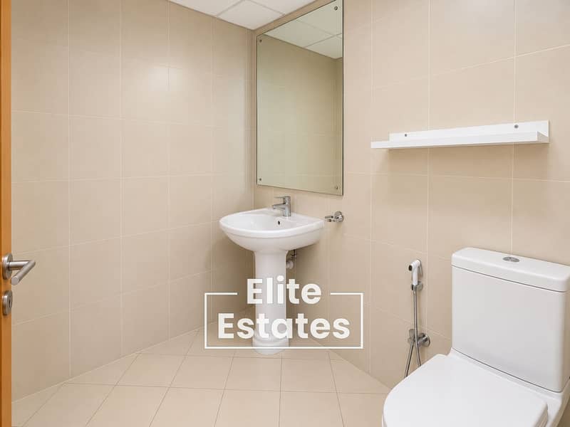 11 Minimalist Beige-Tiled Bathroom Interior. png