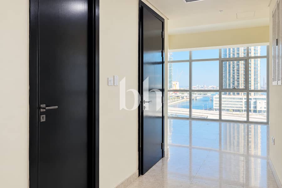 8 Sunlit Empty Roomwith Waterfront Skyline 1