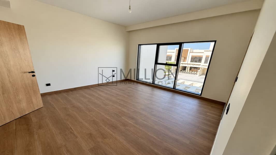 5 Wood-Floored Bedroom with Black-Framed Window-3. png