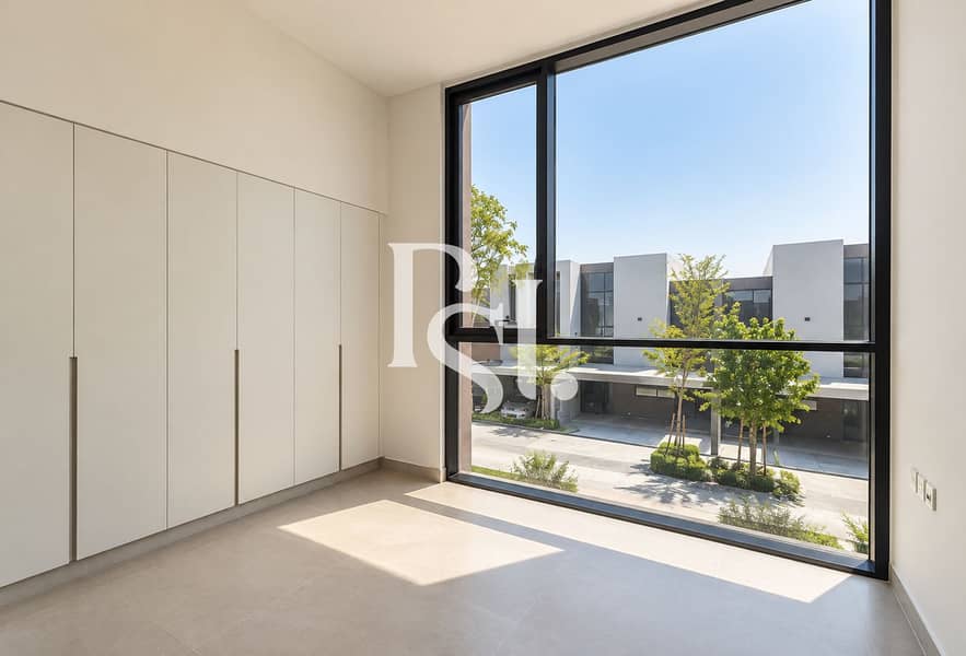 2 Sunlit Minimalist Room with Modern Wardrobes. png