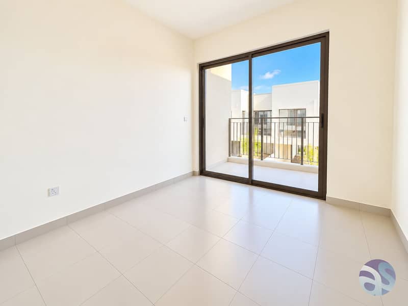 12 Sunlit Minimalist Room with Balcony View. png