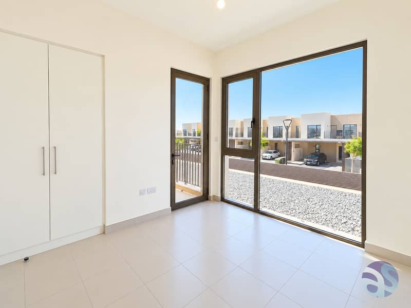 15 Bright Minimalist Room with Townhouse View. png