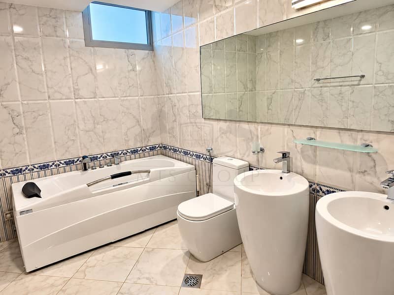 10 Modern Marble Bathroom with Blue Tile Trim. png