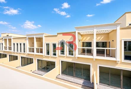 4 Bedroom Townhouse for Rent in DAMAC Lagoons, Dubai - Modern Beige Townhouses Under Blue Skies. png 4 Bedroom Townhouse for Rent in DAMAC Lagoons, Dubai - Modern Beige Townhouses Under Blue Skies. png