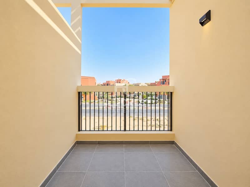 14 Minimalist Balcony Framing a Blue-Sky Neighborhood. png