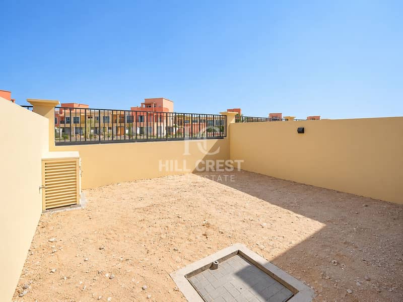 16 Sunlit Courtyard with Colorful Townhomes. png