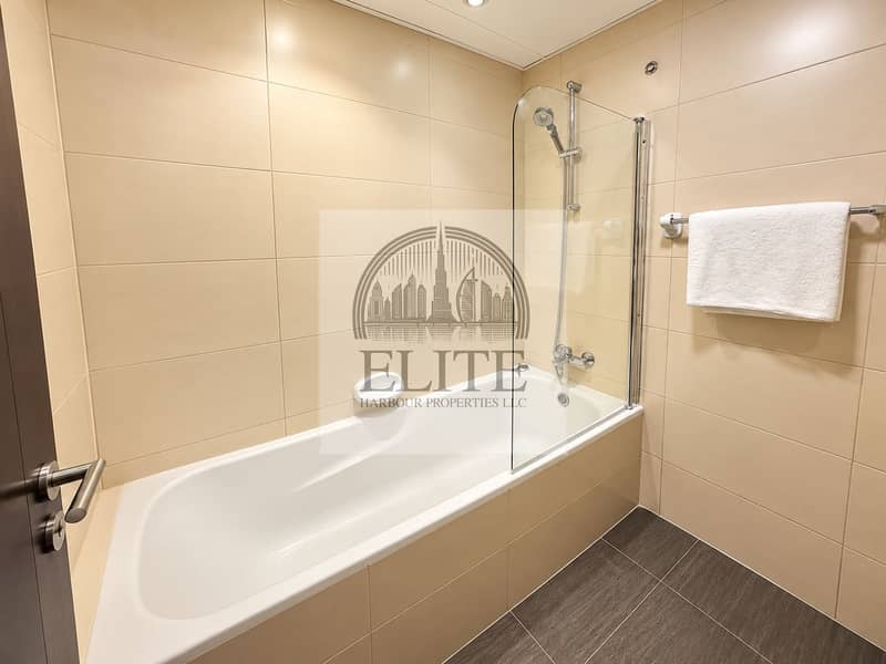 5 Modern Beige Tiled Bathroom with Bathtub. png