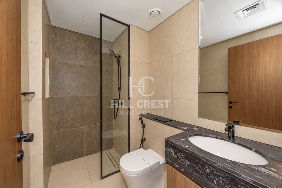 22 Modern Beige Bathroom with Glass Shower. png